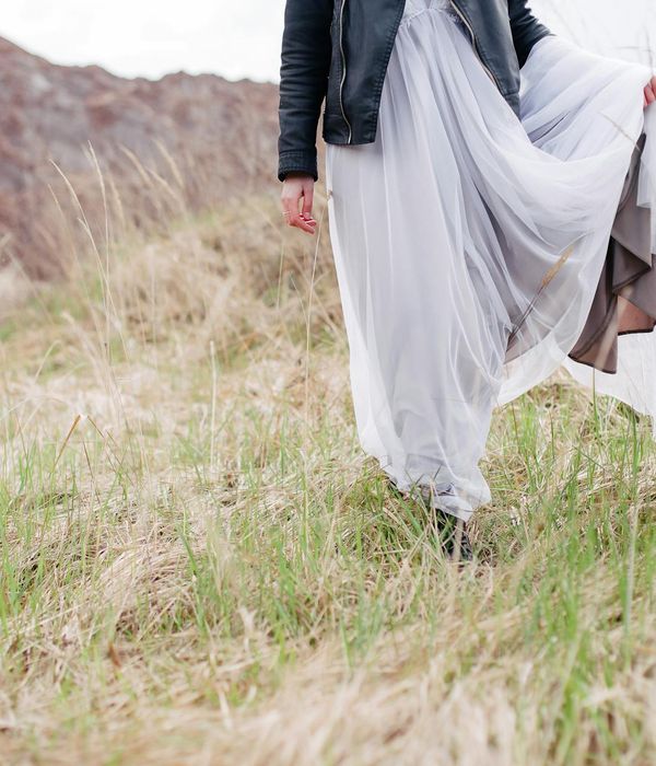 Woman performing a gentle, flowing movement in a bright, airy room.